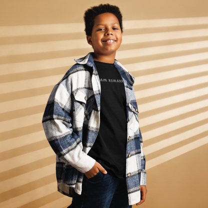 "I am remarkable" printed on a black youth classic tee worn by a male also wearing a jacket