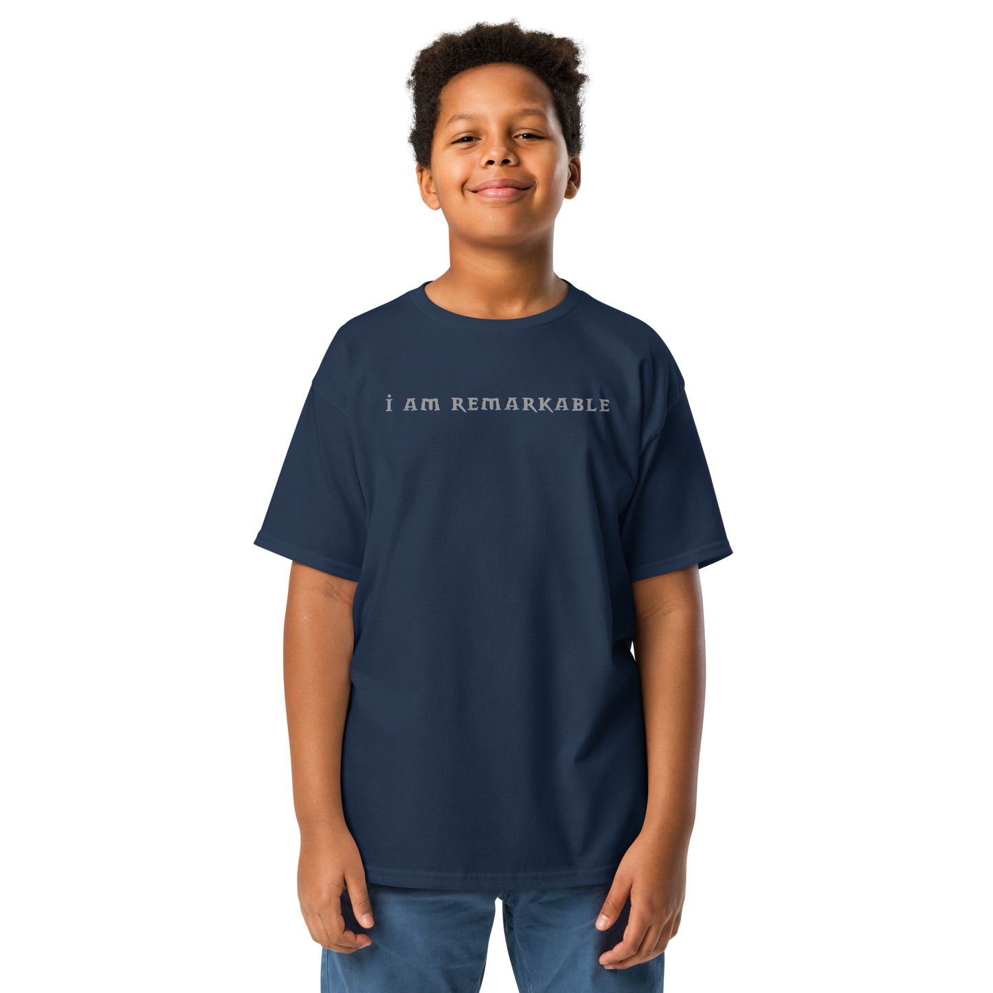 "I am remarkable" printed on a navy youth classic tee worn by a male