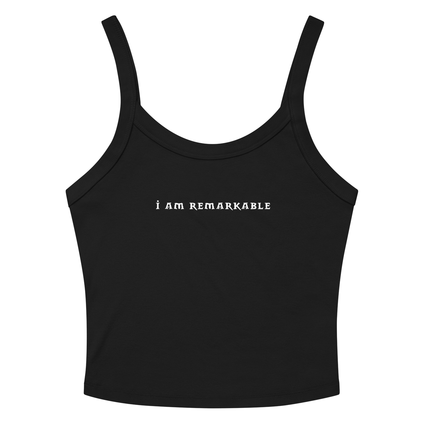 "I am remarkable" printed on a solid black blend women's micro-rib tanktop laying on a flat surface amongst sunglasses and shorts