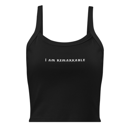 "I am remarkable" printed on a solid black blend women's micro-rib tanktop laying on a flat surface