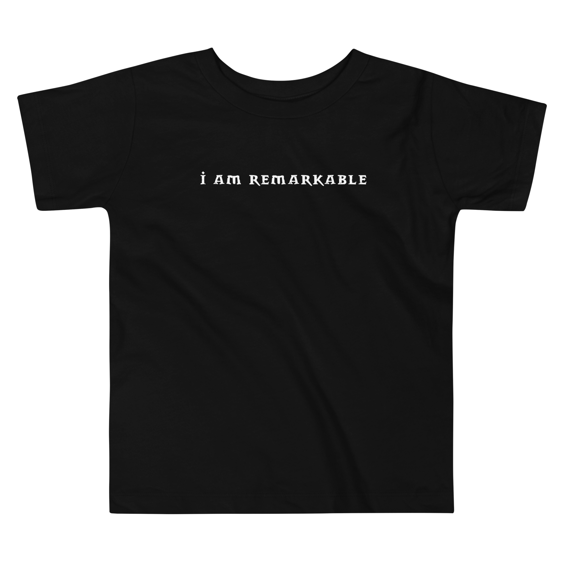 "I am remarkable" printed on a black toddler short sleeve tee laying on a flat surface
