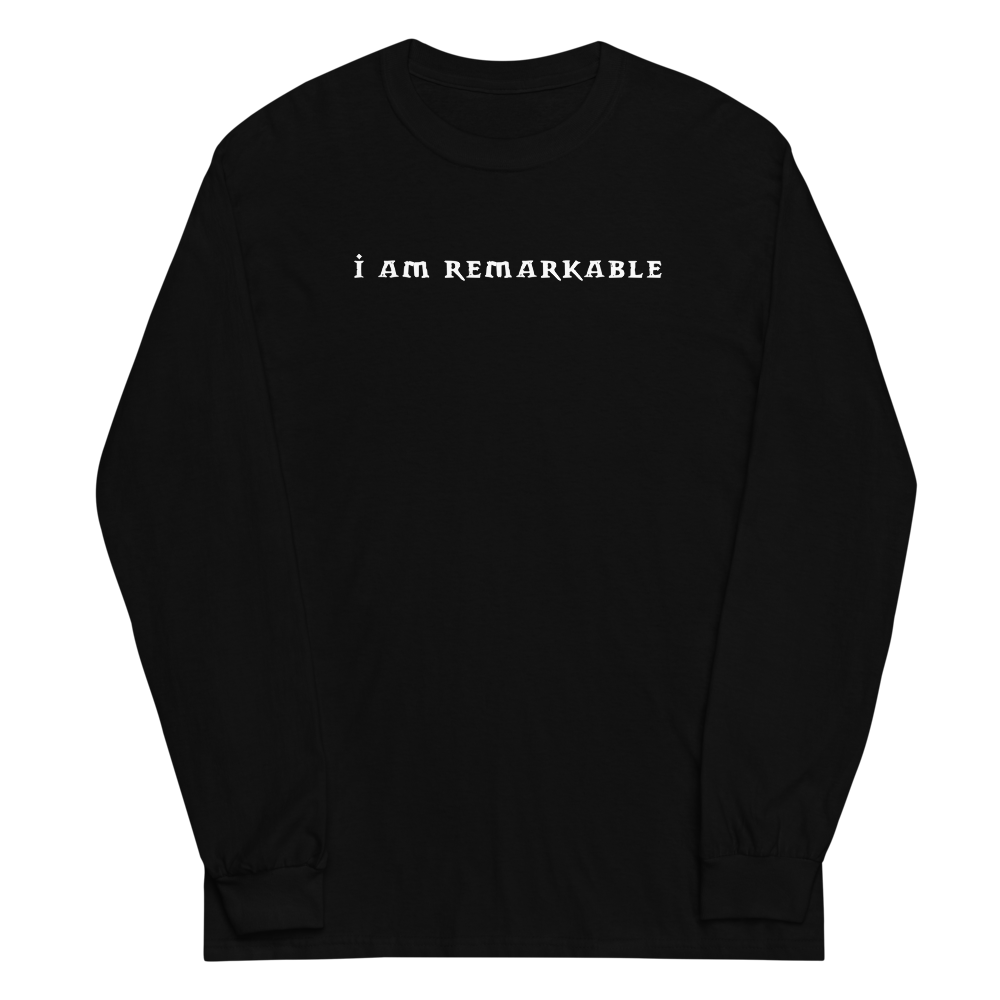 "I am remarkable" printed on a black men's long sleeve shirt laying on a flat surface