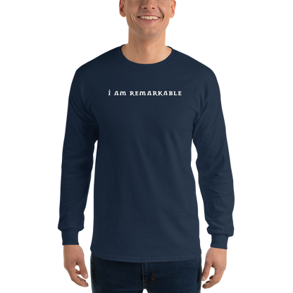 "I am remarkable" printed on a navy men's long sleeve shirt worn by a male