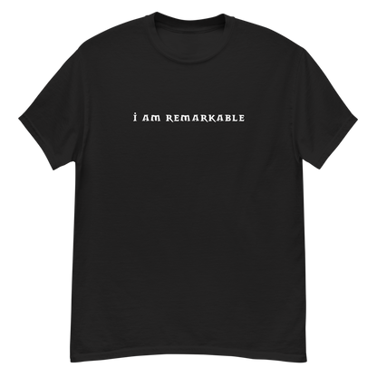 "I am remarkable" printed on a black unisex classic tee laying on a flat surface