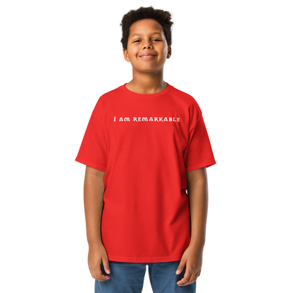"I am remarkable" printed on a red youth classic tee worn by a male
