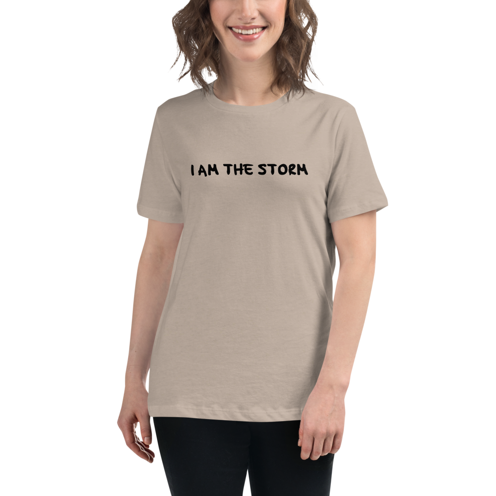 "I am the storm" printed on a heather stone women's relaxed t-shirt worn by a female