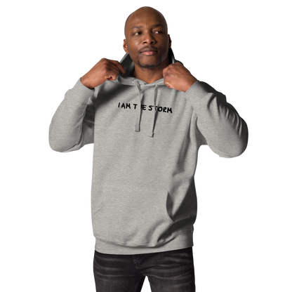 "I am the storm" printed on a carbon grey unisex hoodie worn by a male