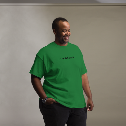 "I am the storm" printed on a turf green unisex classic tee worn by a male