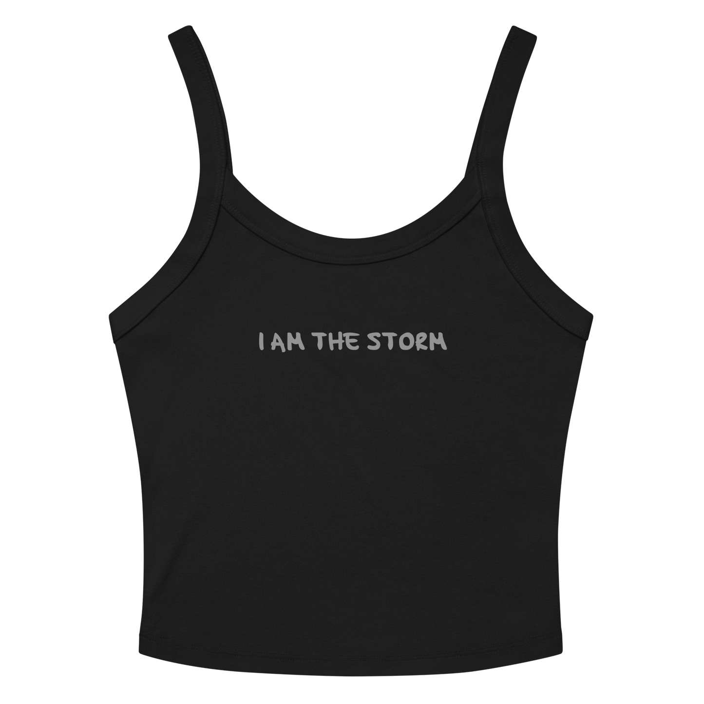 "I am the storm" printed on a solid black blend women's micro-rib tanktop laying on a flat surface amongst sunglasses and shorts