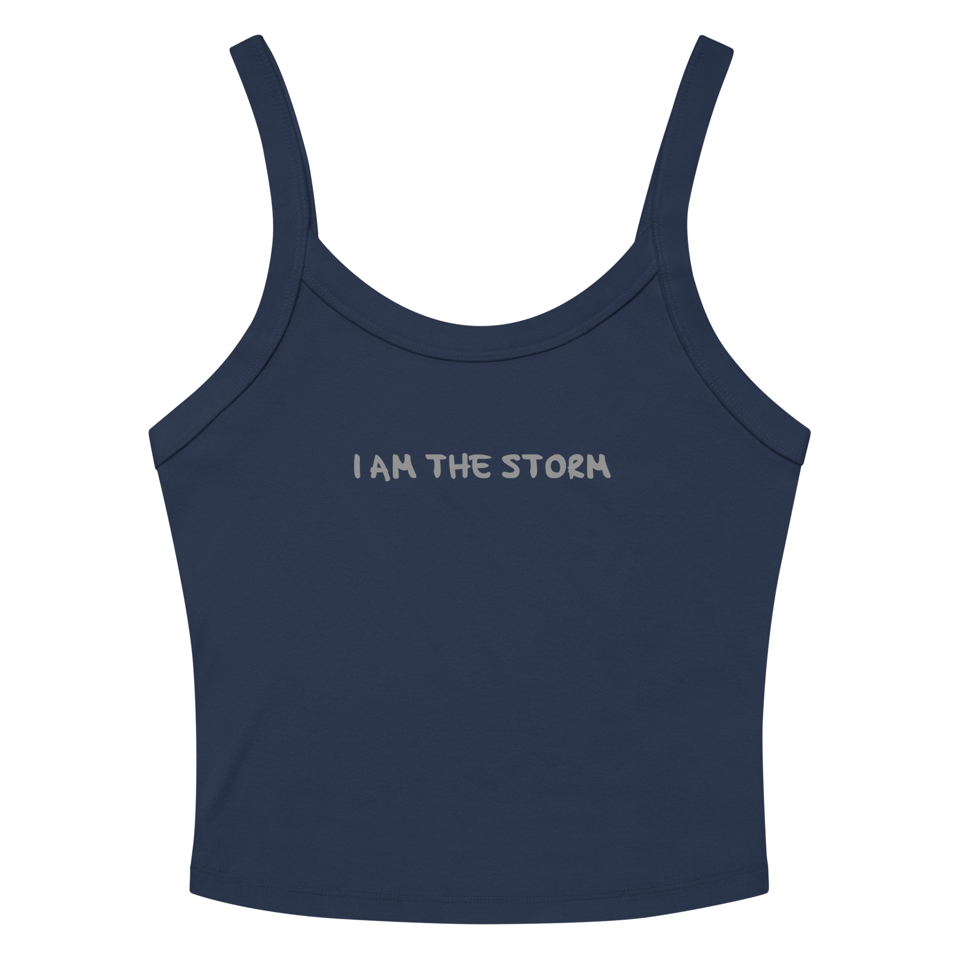 "I am the storm" printed on a solid navy blend women's micro-rib tanktop laying on a flat surface amongst sunglasses and shorts