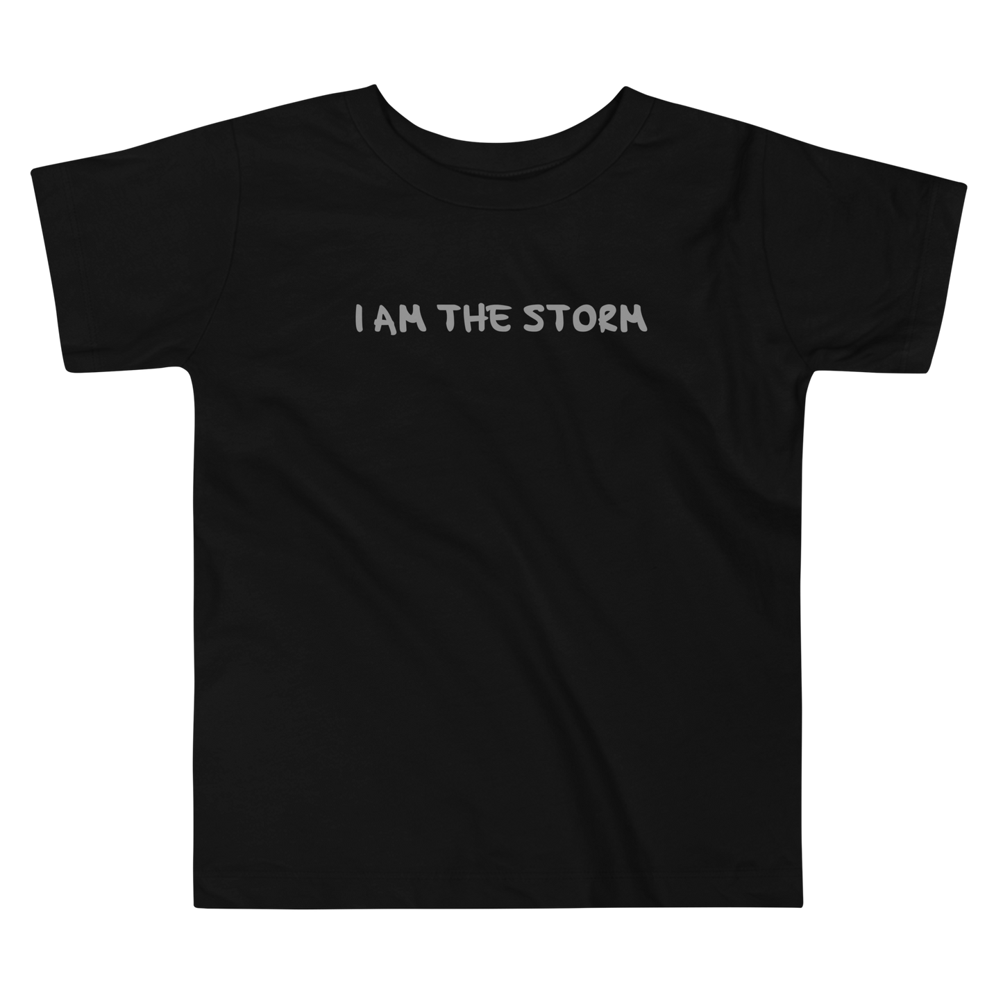 "I am the storm" printed on a black toddler short sleeve tee laying on a flat surface