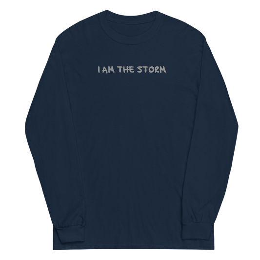 "I am the storm" printed on a navy men's long sleeve shirt laying on a flat surface
