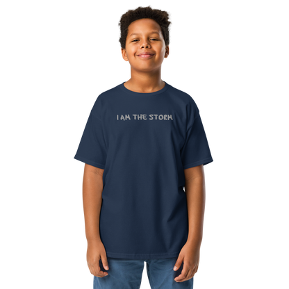 "I am the storm" printed on a navy youth classic tee worn by a male