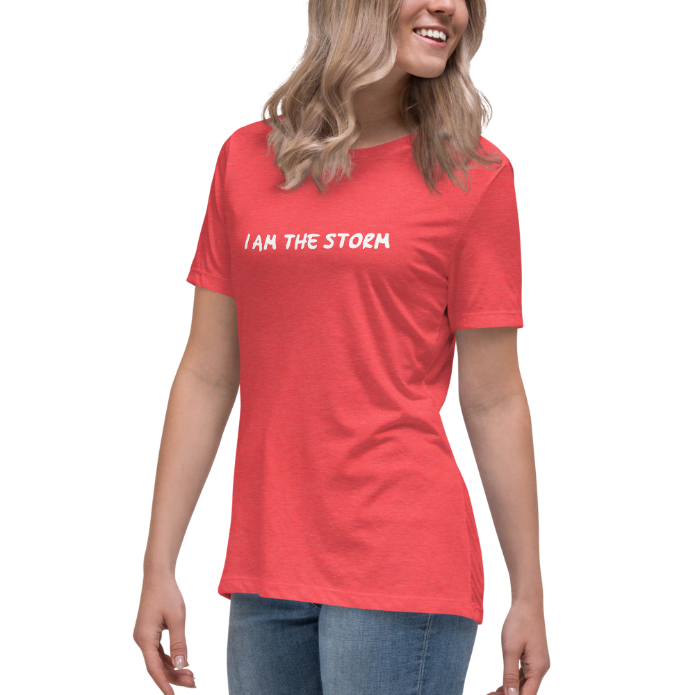 "I am the storm" printed on a heather red women's relaxed t-shirt worn by a female