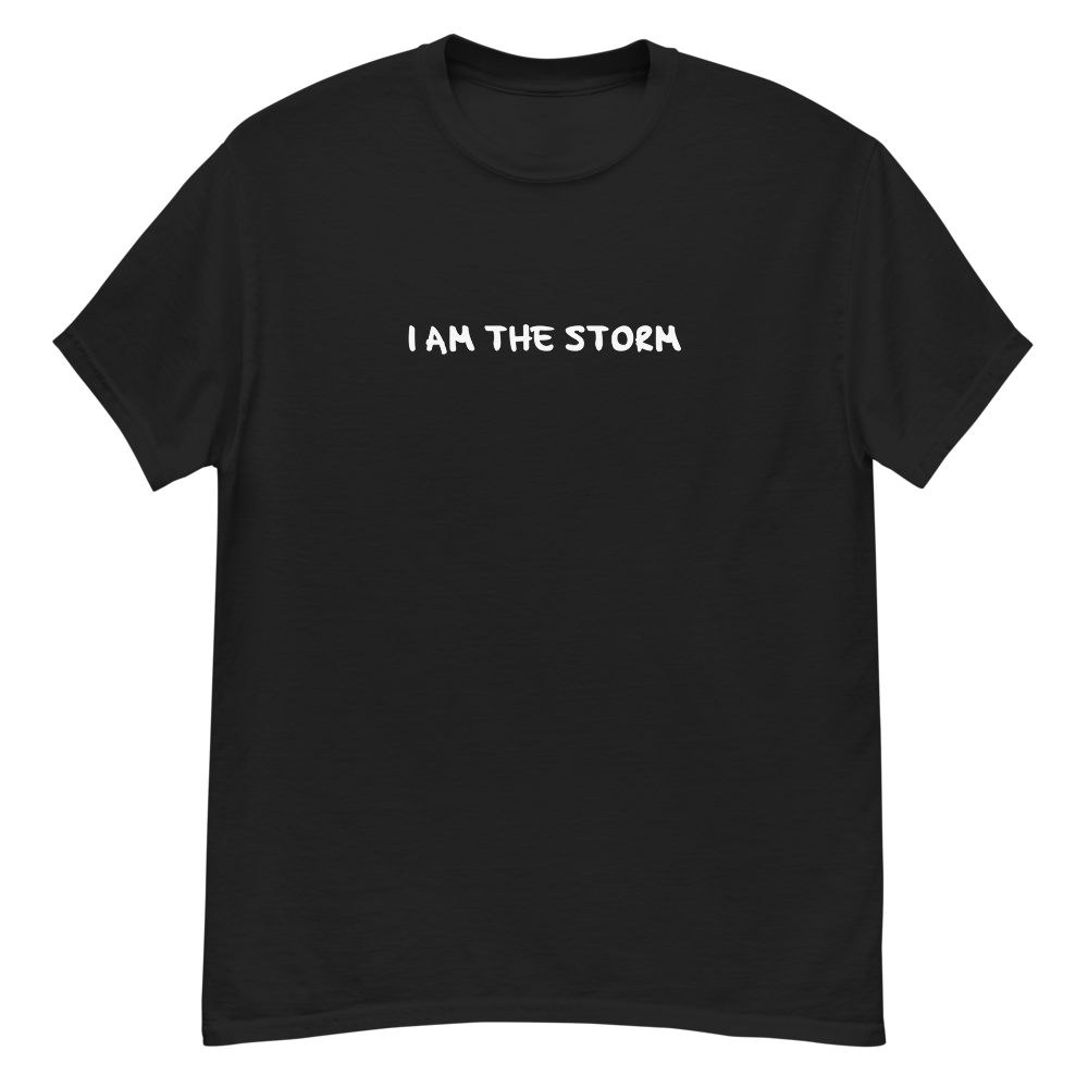 "I am the storm" printed on a black unisex classic tee laying on a flat surface
