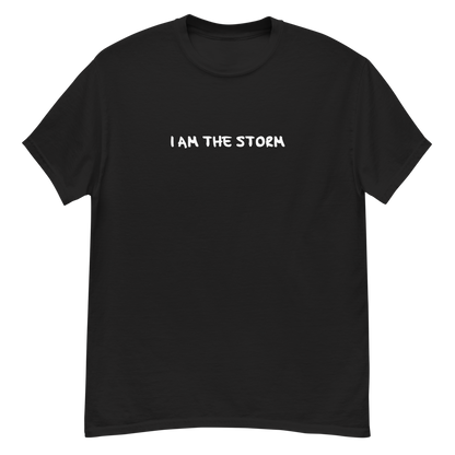 "I am the storm" printed on a black unisex classic tee laying on a flat surface