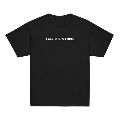 "I am the storm" printed on a black youth classic tee laying on a flat surface