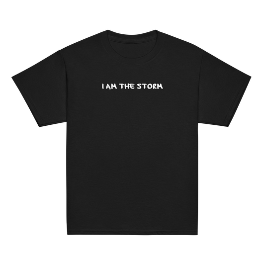 "I am the storm" printed on a black youth classic tee laying on a flat surface