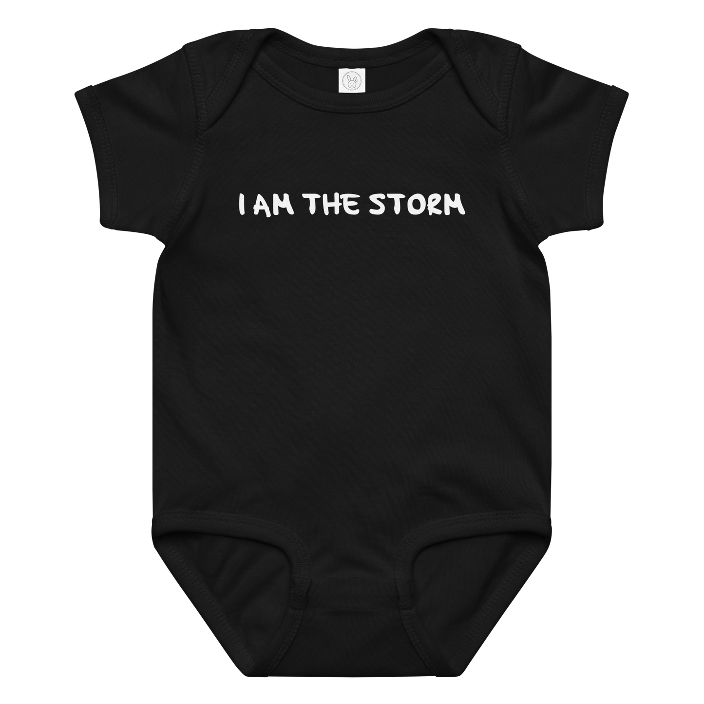 "I am the storm" printed on a black baby jersey bodysuit laying on a flat surface amongst other clothes
