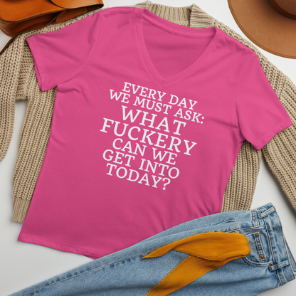"Every day we must ask: What fuckery can we get into today?" printed on a berry women's relaxed v-neck t-shirt laying on a flat surface amongst other clothes