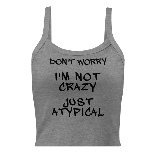 "Don't Worry I'm Not Crazy Just Atypical" printed on a athletic heather women's micro-rib tanktop laying on a flat surface