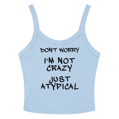 "Don't Worry I'm Not Crazy Just Atypical" printed on a solid baby blue blend women's micro-rib tanktop laying on a flat surface amongst sunglasses and shorts