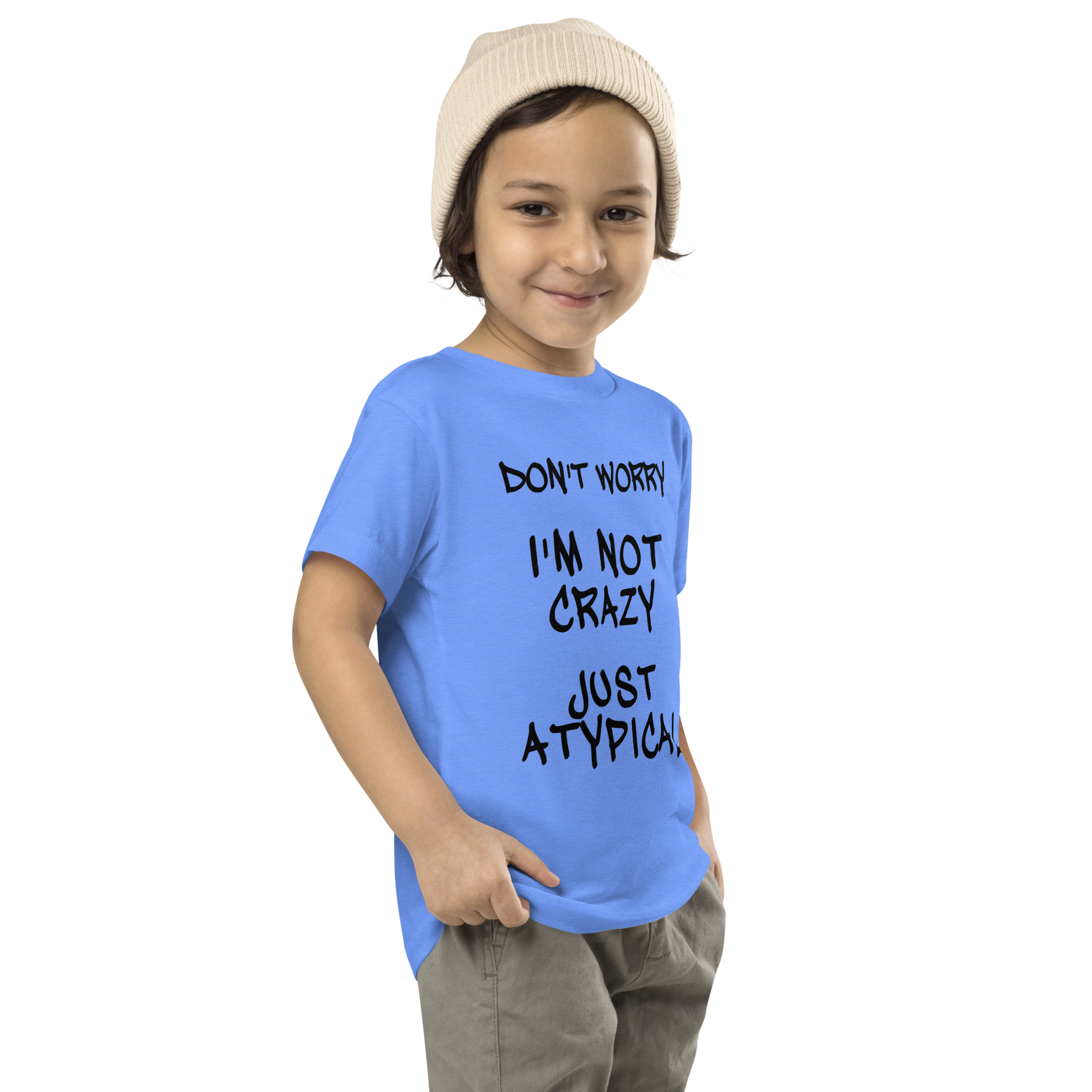 "Don't Worry I'm Not Crazy Just Atypical" printed on a heather columbia blue toddler short sleeve tee worn by a male who is also wearing a knit cap