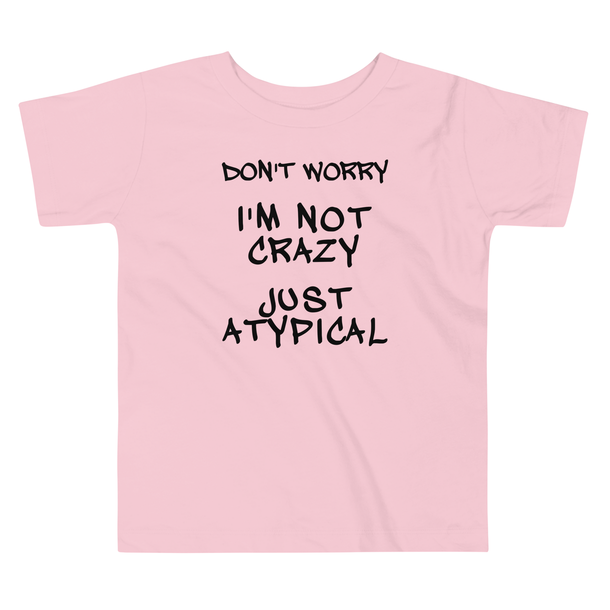 "Don't Worry I'm Not Crazy Just Atypical" printed on a pink toddler short sleeve tee laying on a flat surface