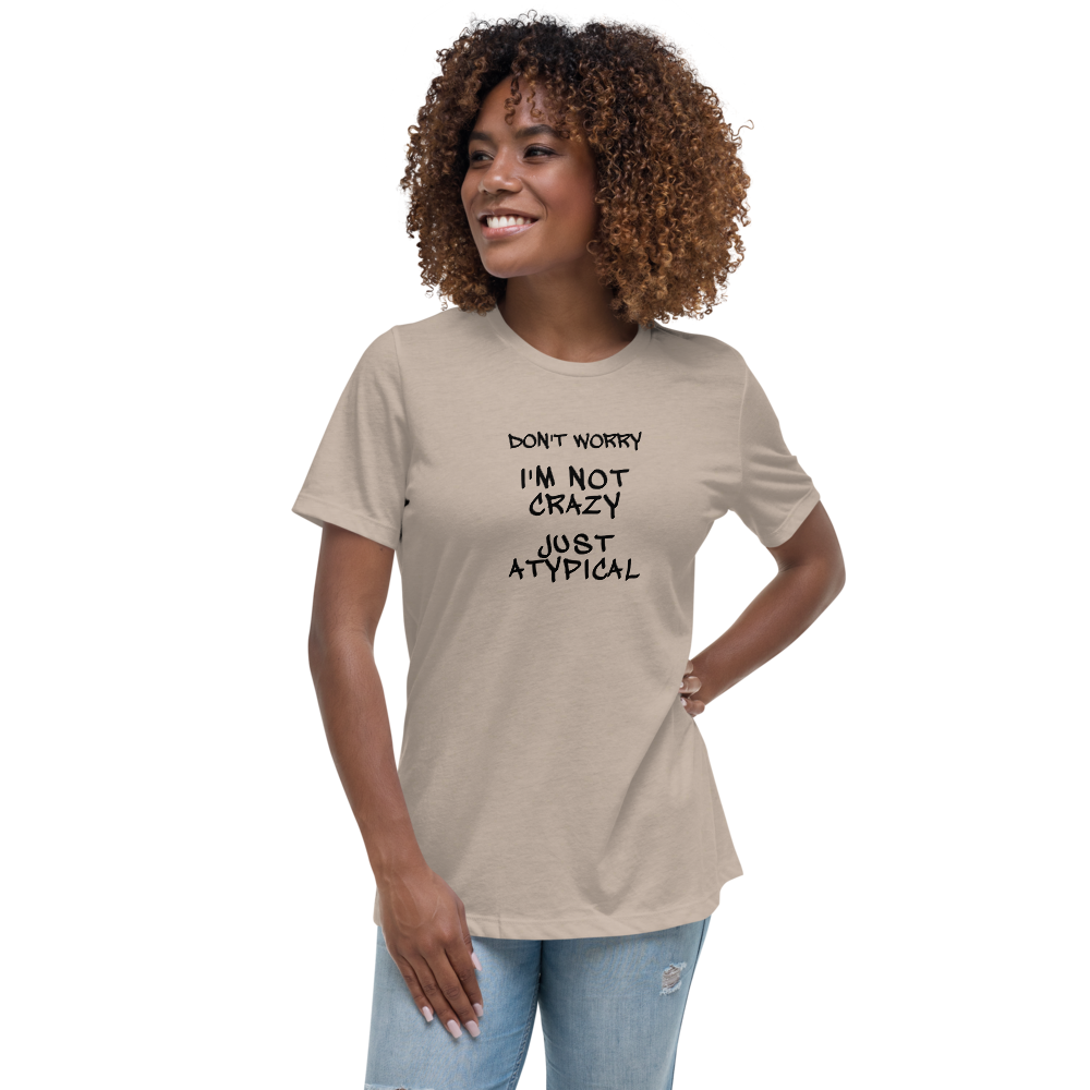 "Don't Worry I'm Not Crazy Just Atypical" printed on a heather stone women's relaxed t-shirt worn by a female