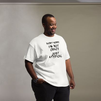 "Don't Worry I'm Not Crazy Just Atypical" printed on a white unisex classic tee worn by a male