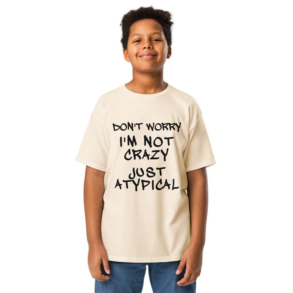 "Don't Worry I'm Not Crazy Just Atypical" printed on a natural youth classic tee worn by a male