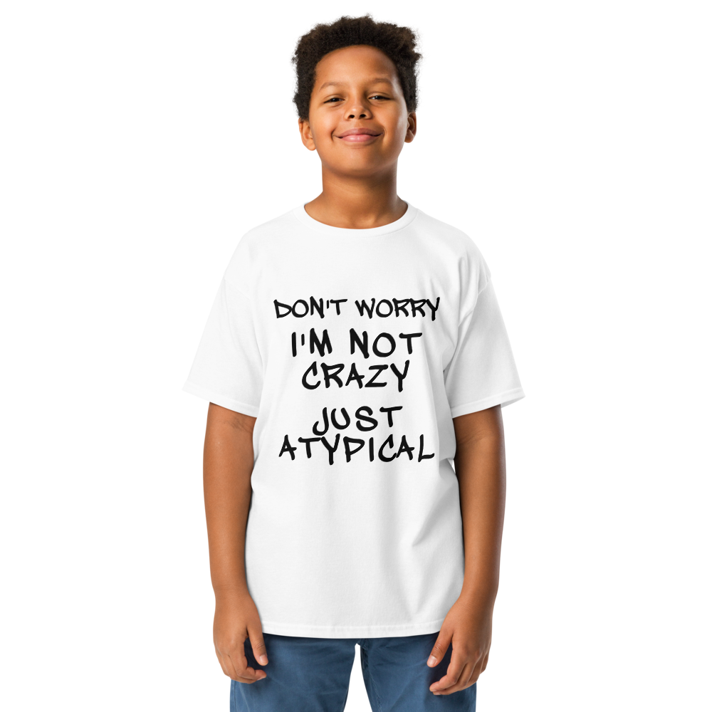 "Don't Worry I'm Not Crazy Just Atypical" printed on a white youth classic tee worn by a male