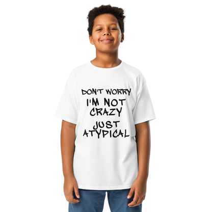 "Don't Worry I'm Not Crazy Just Atypical" printed on a white youth classic tee worn by a male