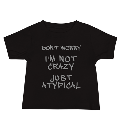 "Don't Worry I'm Not Crazy Just Atypical" printed on a black baby jersey short sleeve tee laying on a flat surface
