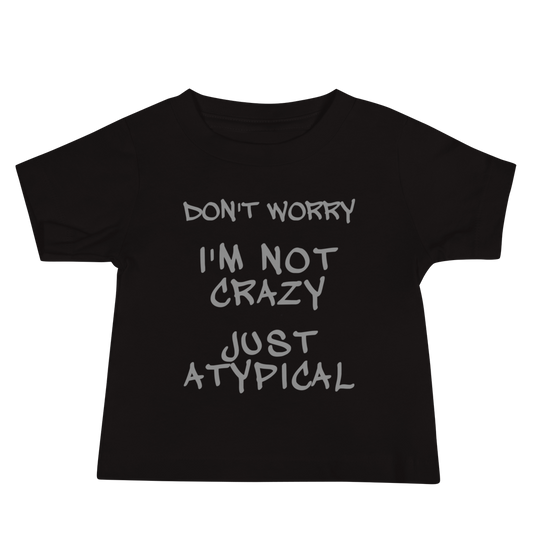 "Don't Worry I'm Not Crazy Just Atypical" printed on a black baby jersey short sleeve tee laying on a flat surface