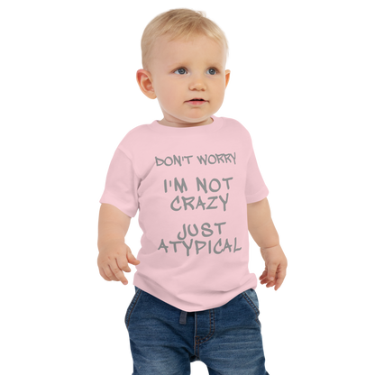 "Don't Worry I'm Not Crazy Just Atypical" printed on a pink baby jersey short sleeve tee worn by a male
