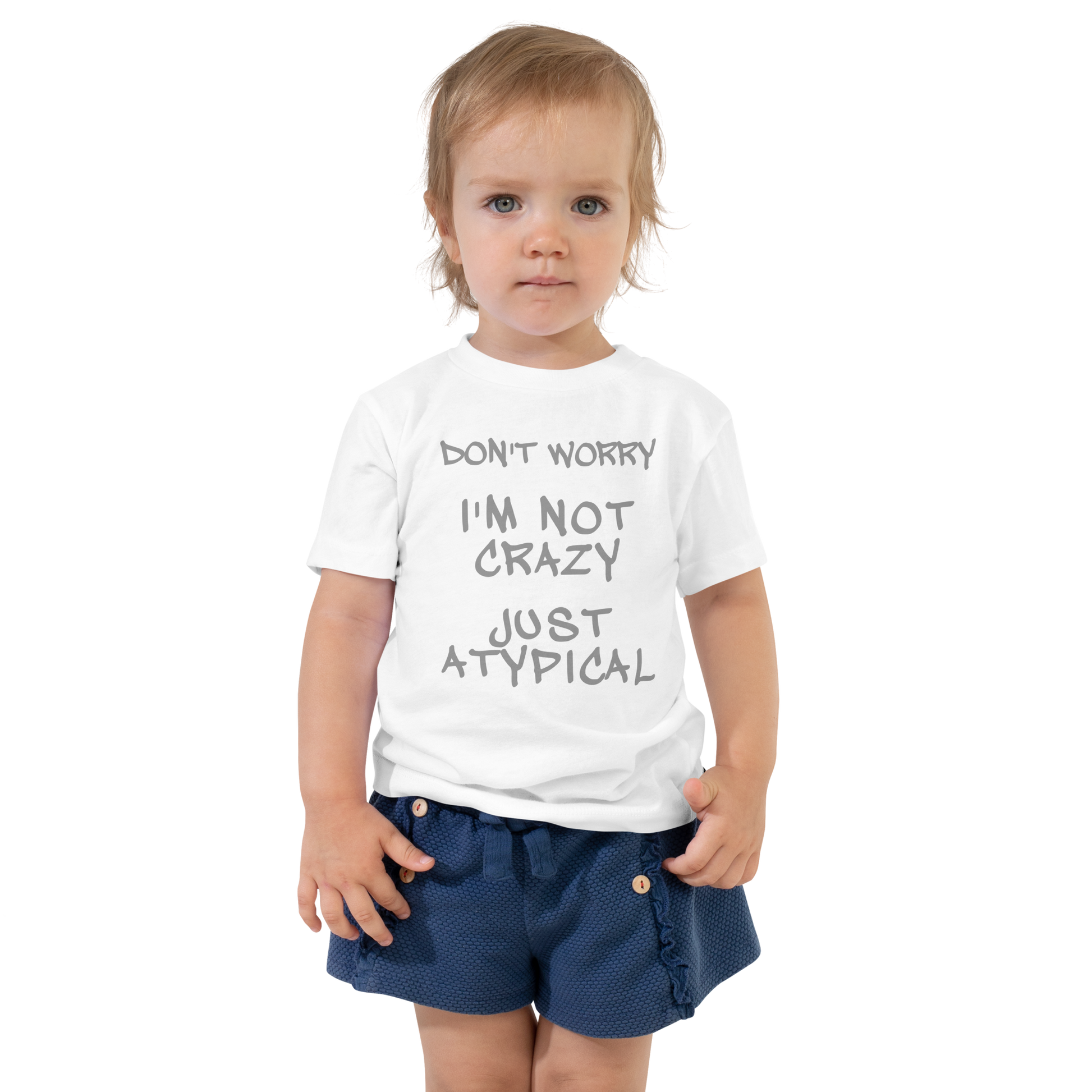 "Don't Worry I'm Not Crazy Just Atypical" printed on a white toddler short sleeve tee worn by a female