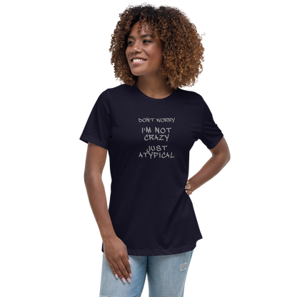"Don't Worry I'm Not Crazy Just Atypical" printed on a navy women's relaxed t-shirt worn by a female