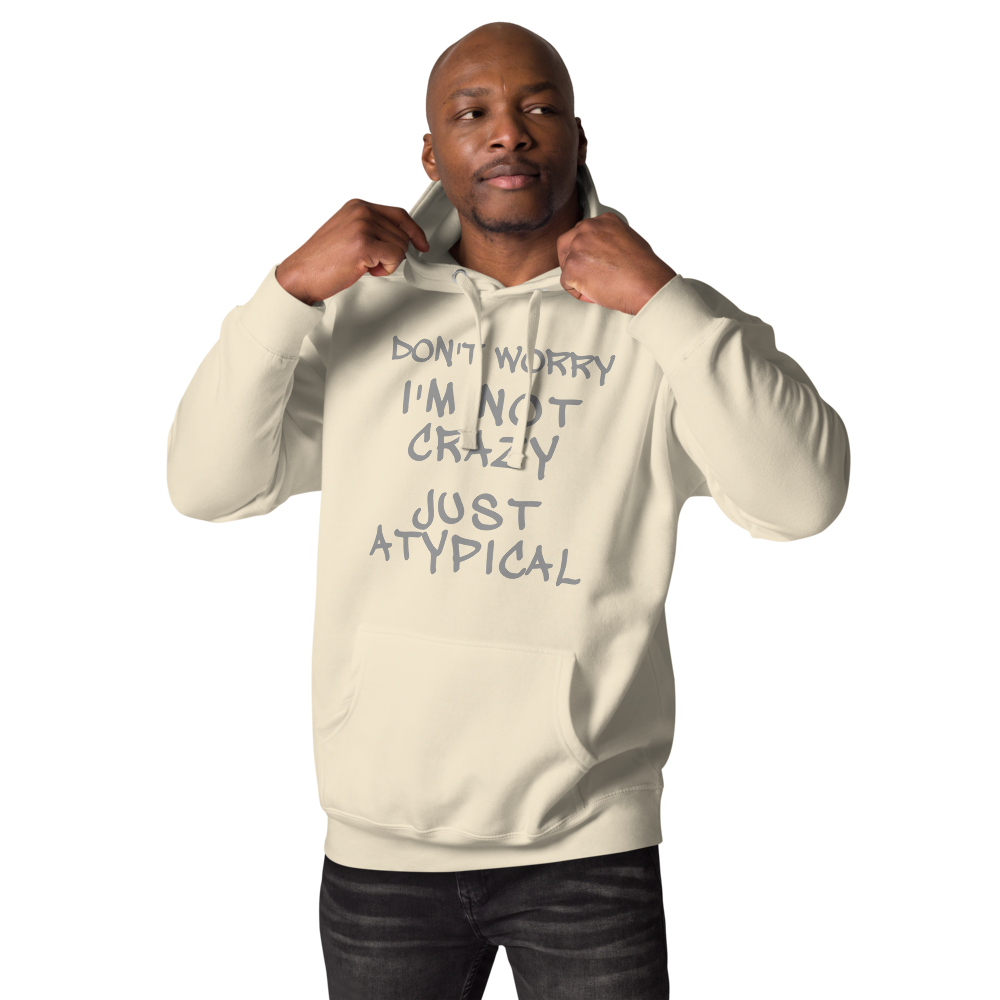 "Don't Worry I'm Not Crazy Just Atypical" printed on a bone unisex hoodie worn by a male