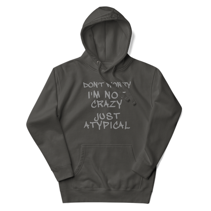 "Don't Worry I'm Not Crazy Just Atypical" printed on a vintage black unisex hoodie laying on a flat surface with the hood up
