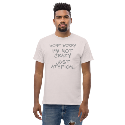 "Don't Worry I'm Not Crazy Just Atypical" printed on a ice grey unisex classic tee worn by a male