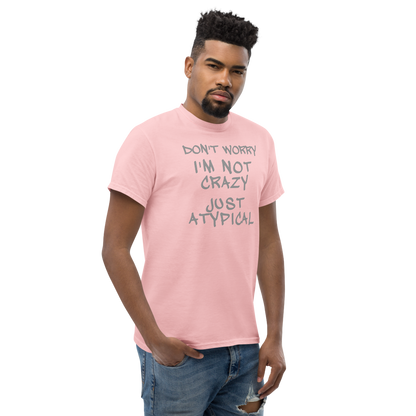 "Don't Worry I'm Not Crazy Just Atypical" printed on a light pink unisex classic tee worn by a male