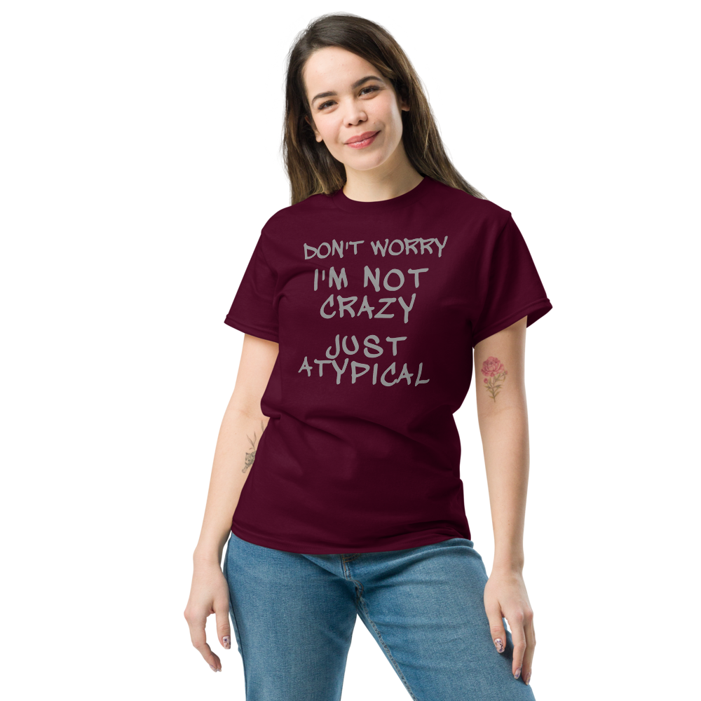 "Don't Worry I'm Not Crazy Just Atypical" printed on a maroon unisex classic tee worn by a female