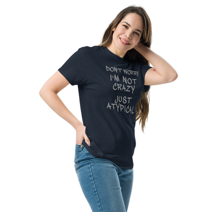 "Don't Worry I'm Not Crazy Just Atypical" printed on a navy unisex classic tee worn by a female
