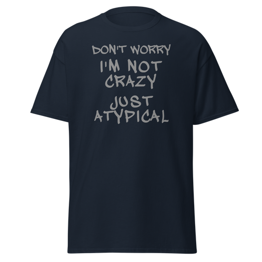 "Don't Worry I'm Not Crazy Just Atypical" printed on a navy unisex classic tee laying on a flat surface