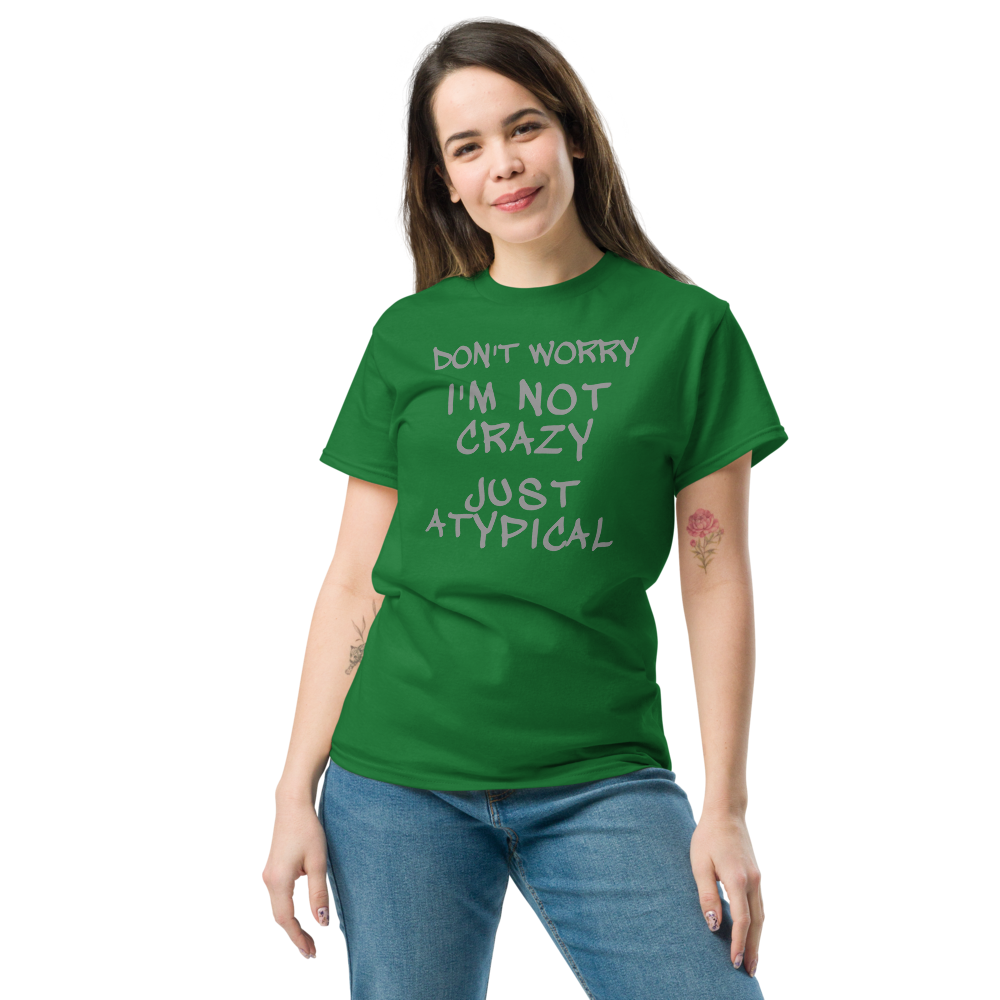 "Don't Worry I'm Not Crazy Just Atypical" printed on a turf green unisex classic tee worn by a female
