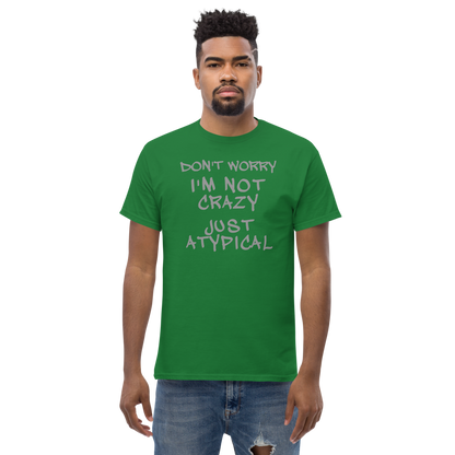 "Don't Worry I'm Not Crazy Just Atypical" printed on a turf green unisex classic tee worn by a male