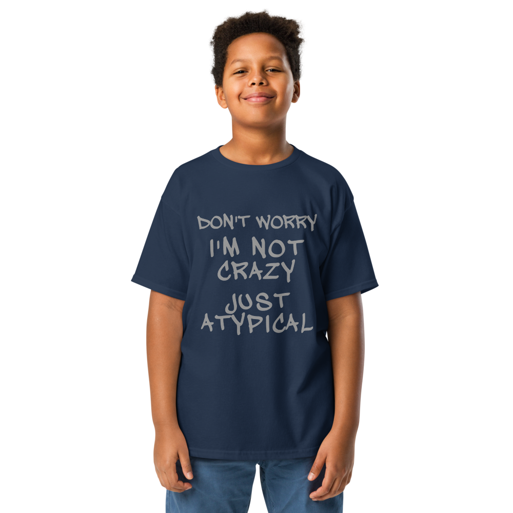 "Don't Worry I'm Not Crazy Just Atypical" printed on a navy youth classic tee worn by a male