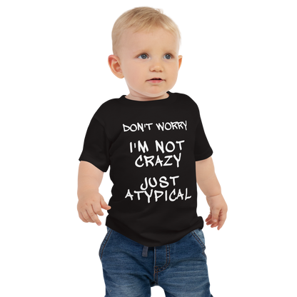 "Don't Worry I'm Not Crazy Just Atypical" printed on a black baby jersey short sleeve tee worn by a male