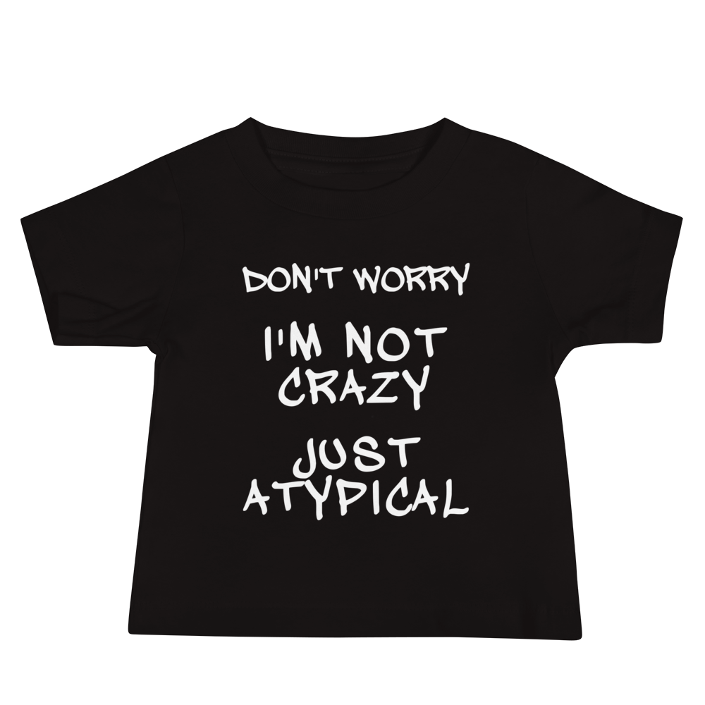"Don't Worry I'm Not Crazy Just Atypical" printed on a black baby jersey short sleeve tee laying on a flat surface